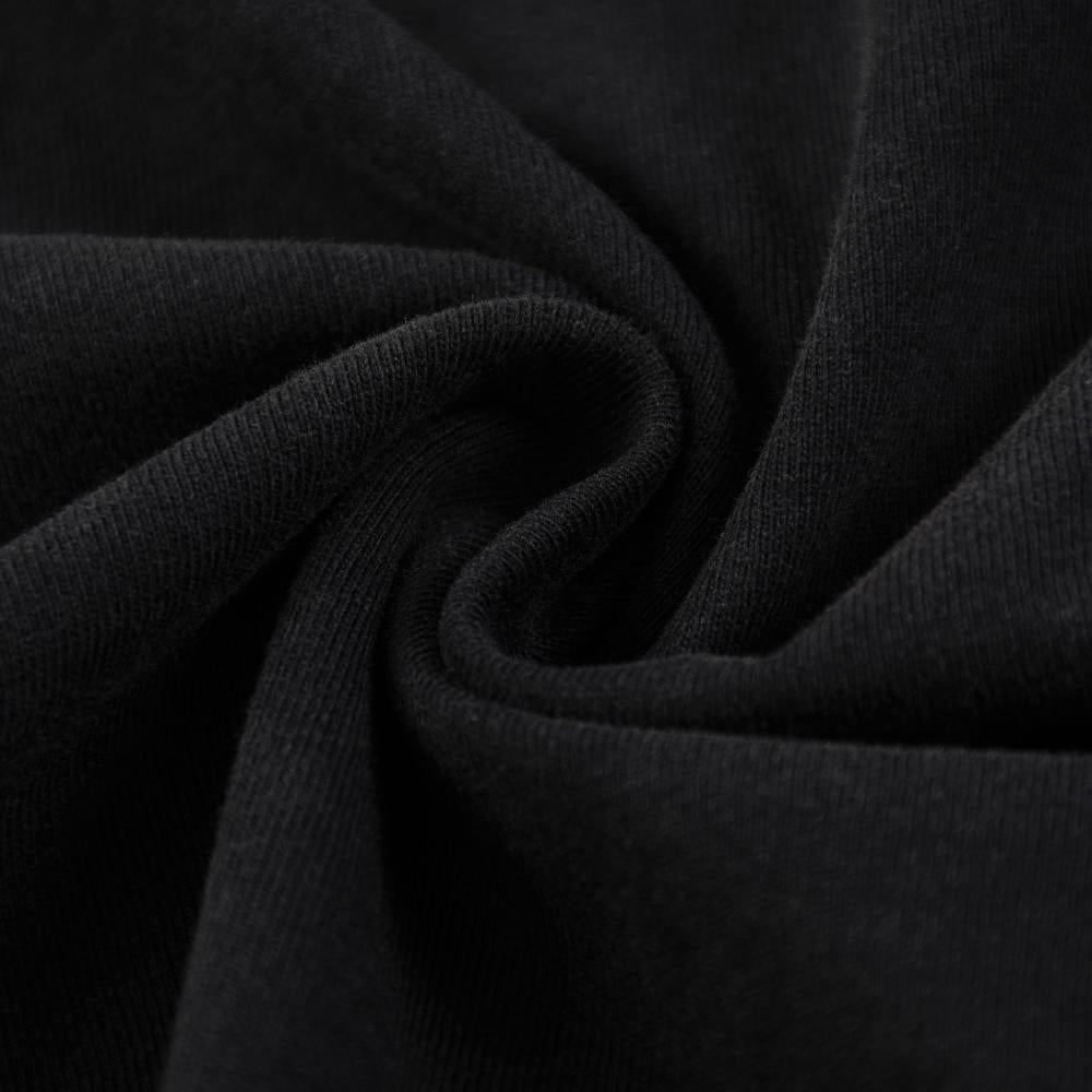 Black enzyme-wash T-shirt fabric close-up, soft cotton texture with gentle stretch