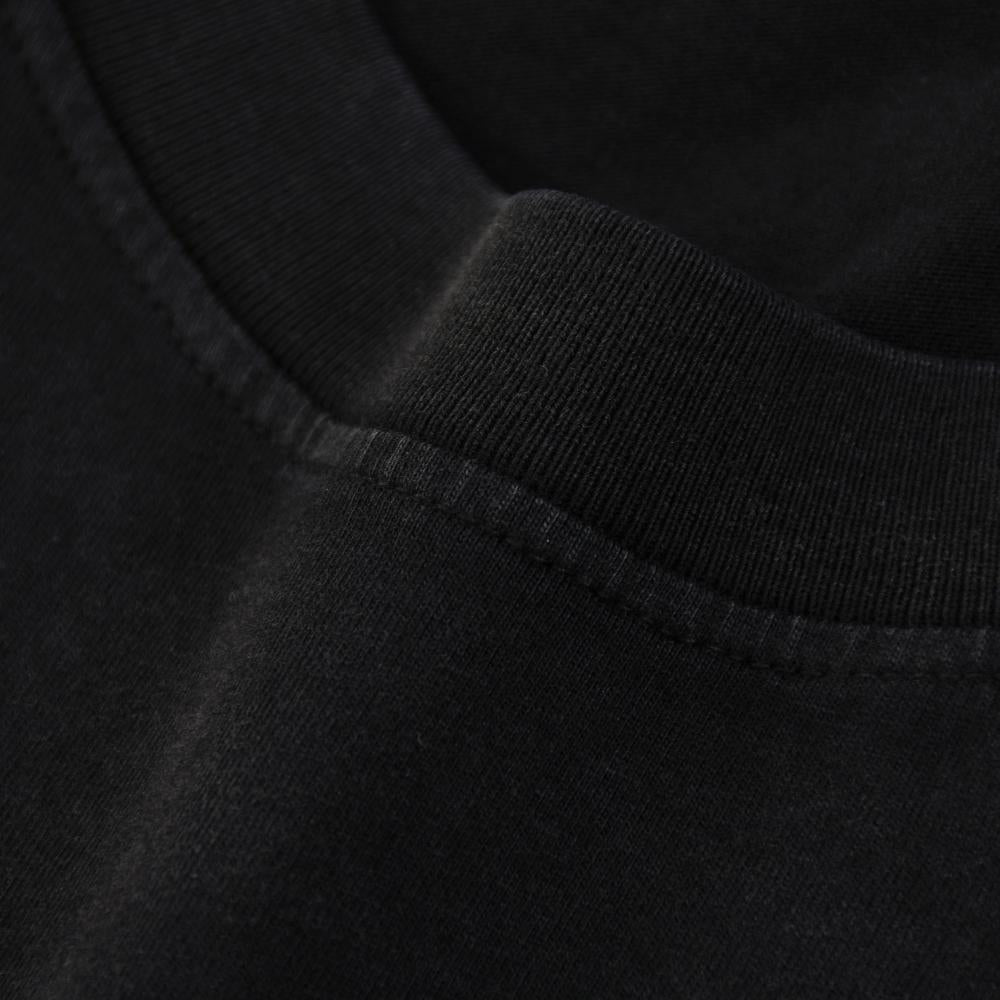 Black enzyme-wash T-shirt ribbed collar and neckline seam close-up