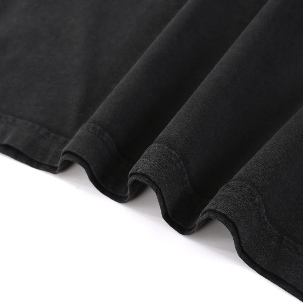 Black enzyme-wash T-shirt hem and edge stitching close-up