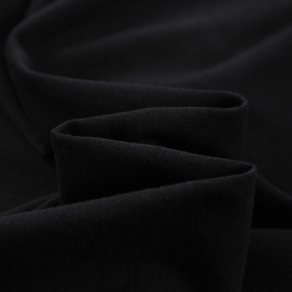Black enzyme-wash T-shirt fabric folds close-up, soft knit texture