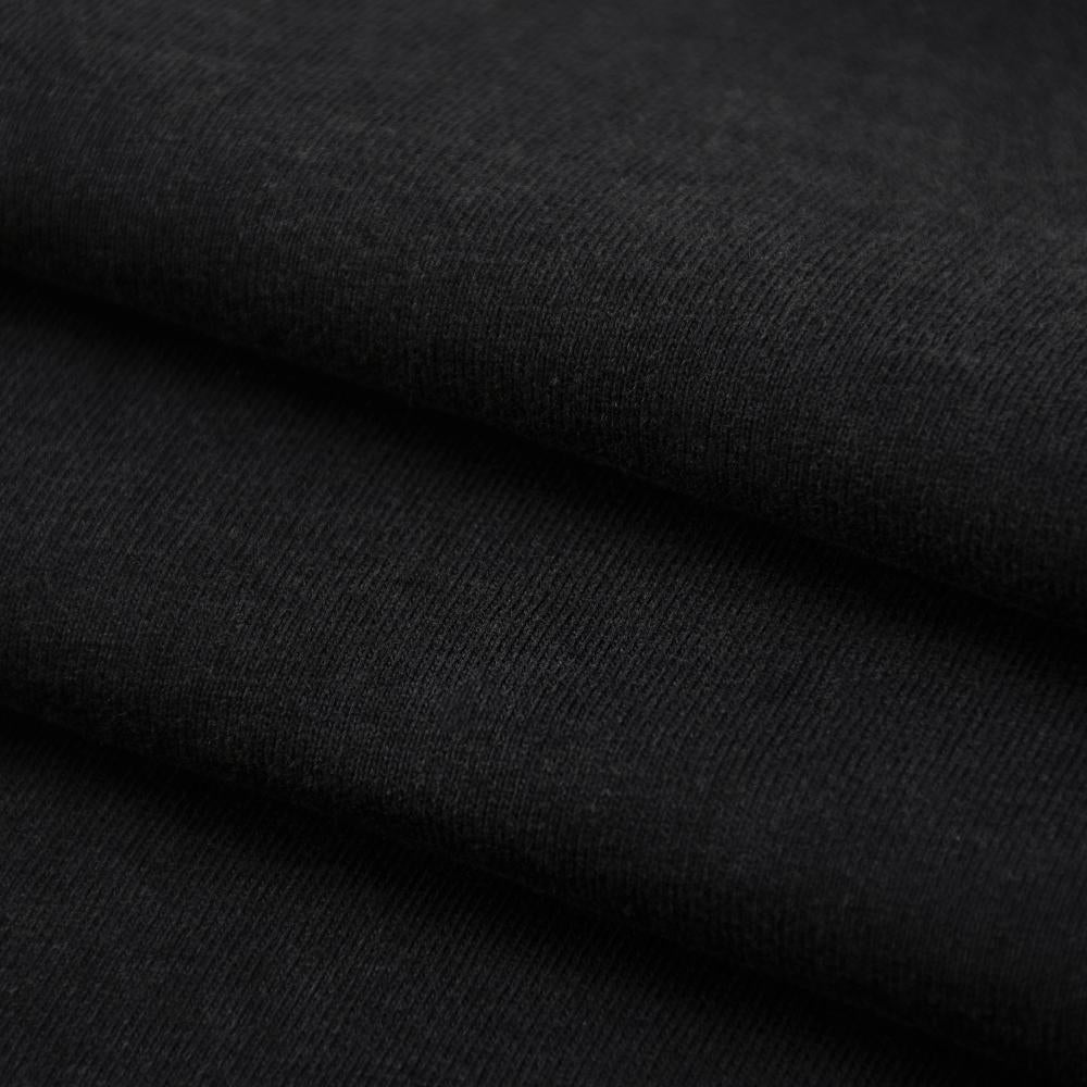 Black enzyme-wash T-shirt fabric close-up, smooth knit with subtle shading