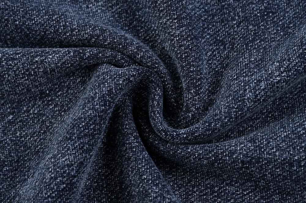 Acid wash fabric texture on oversized crewneck sweatshirt, deep blue-gray