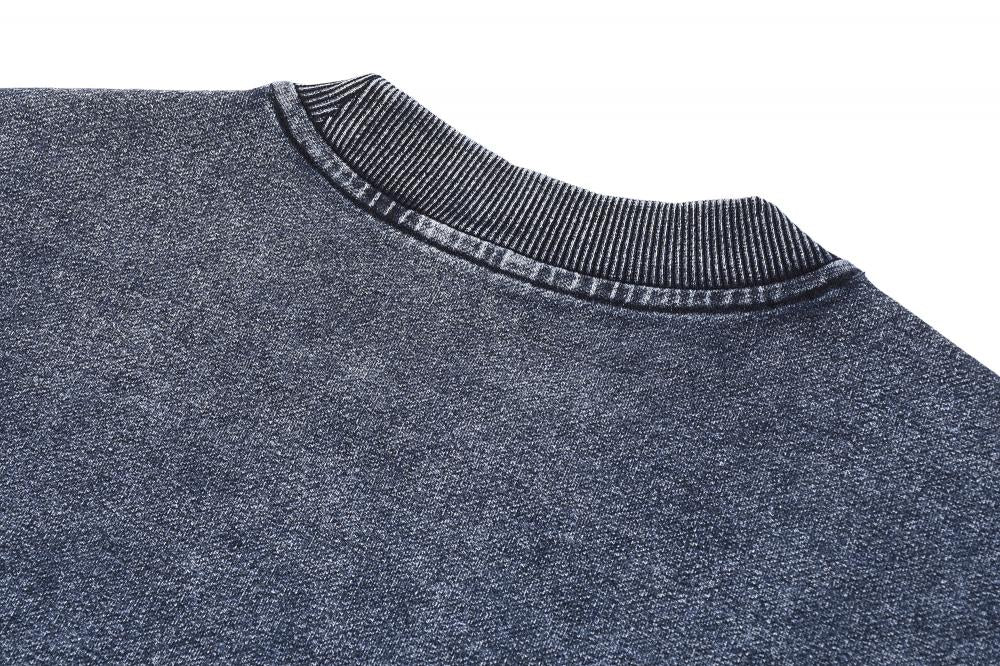 Crewneck and shoulder seam on acid wash oversized sweatshirt, blue-gray fabric