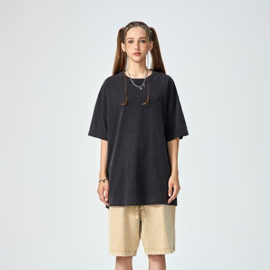 Unisex heavyweight oversized snow-wash T-shirt on model, dark charcoal black
