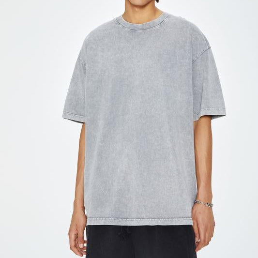 Unisex heavyweight oversized snow-wash T-shirt on model, heather gray