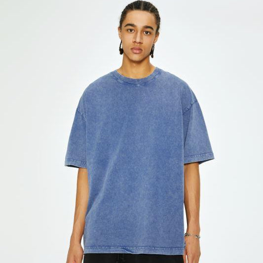 Unisex heavyweight oversized snow-wash T-shirt on model, medium blue