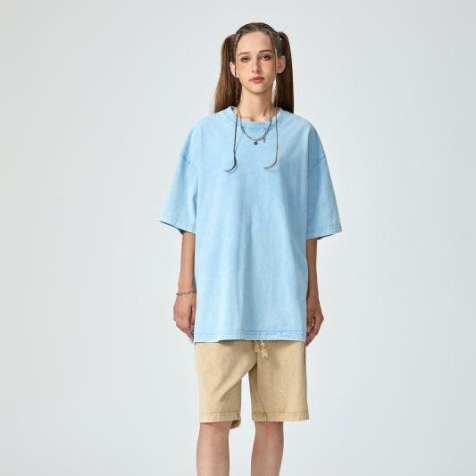 Unisex heavyweight oversized snow-wash T-shirt on model, light blue