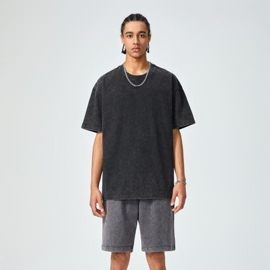 Unisex heavyweight oversized snow-wash T-shirt on model, dark charcoal