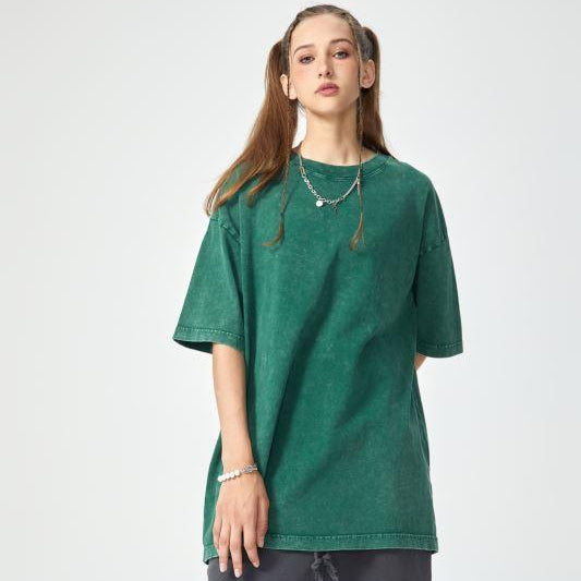Unisex heavyweight oversized snow-wash T-shirt on model, deep green