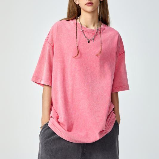Unisex heavyweight oversized snow-wash T-shirt on model, pink rose
