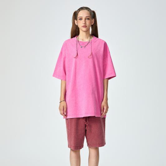 Unisex heavyweight oversized snow-wash T-shirt on model, bright pink