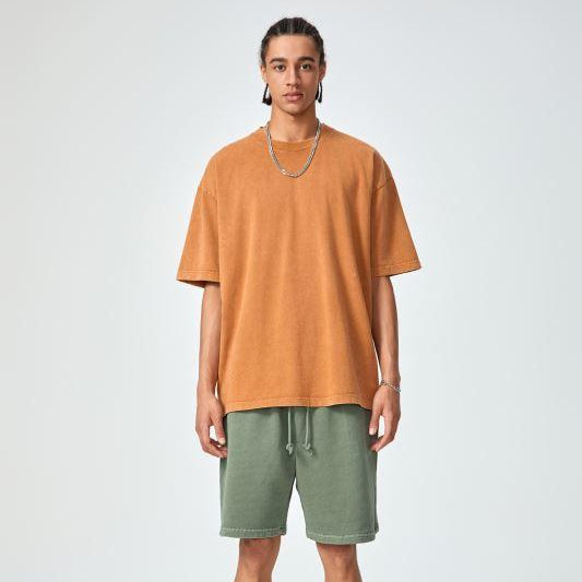 Unisex heavyweight oversized snow-wash T-shirt on model, orange