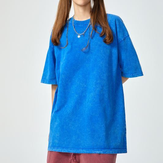 Unisex heavyweight oversized snow-wash T-shirt on model, vivid blue